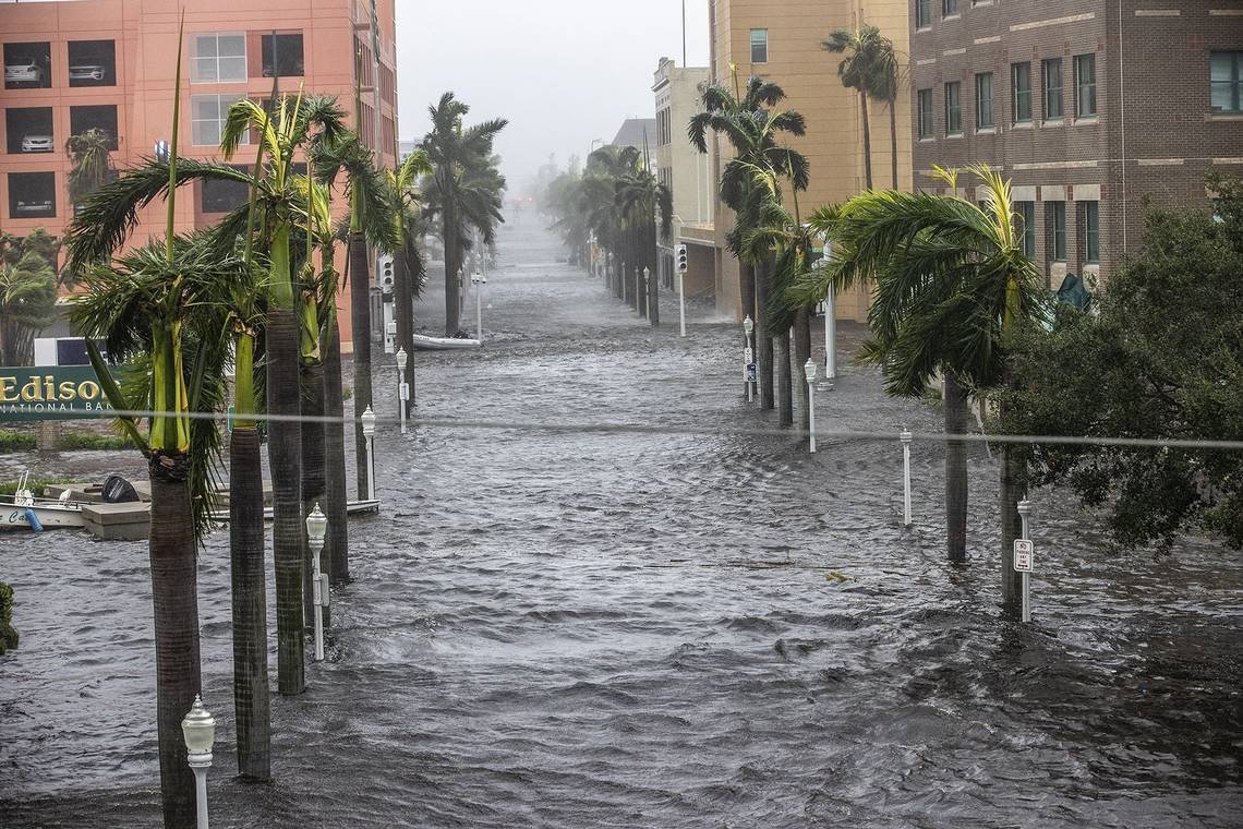 "House surrounded by floodwaters highlighting the importance of flood insurance coverage - Learn more with [Insurance Company Near Me]."